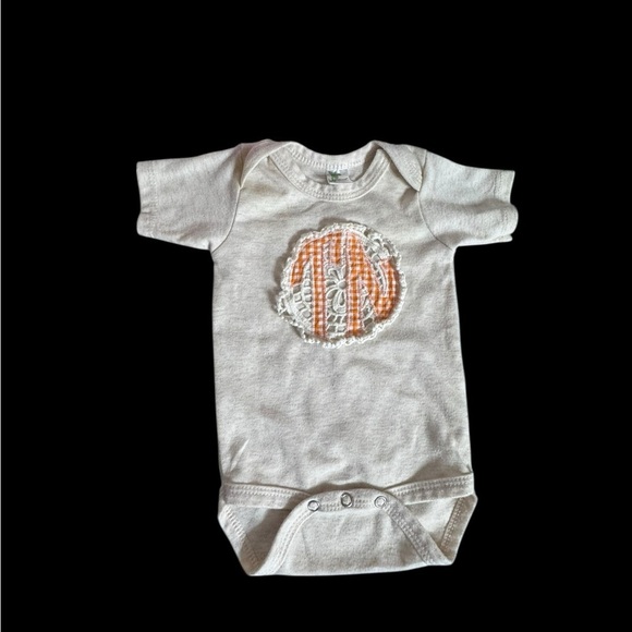 Laughing Giraffe Other - Cream Baby Onesie with Orange “TN” appliqué Design